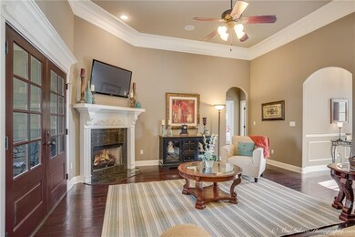 Living room features hardwood flooring and a gas f