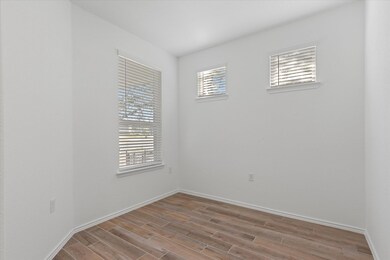 Unfurnished room with baseboards and wood finishe