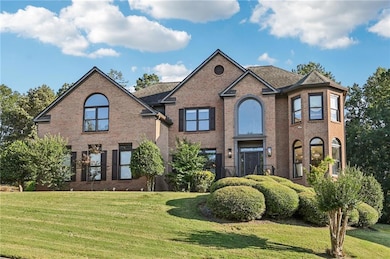 Traditional home featuring brick siding and a front yard