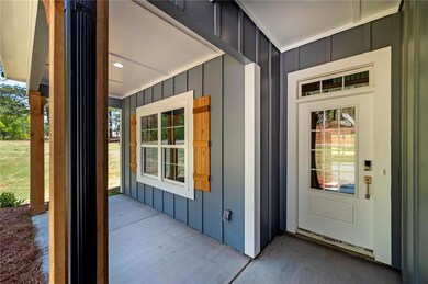 Doorway to property featuring board and batten sid