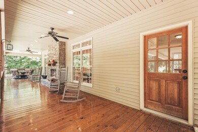 Front porch wraps around to the side with another entry into the house from the carport into the mudroom/laundry room with half bath.