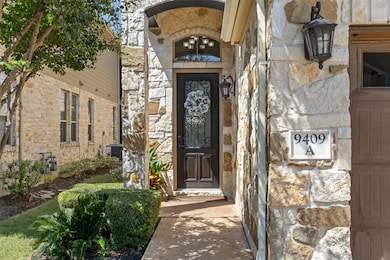 Entrance to property featuring stone siding