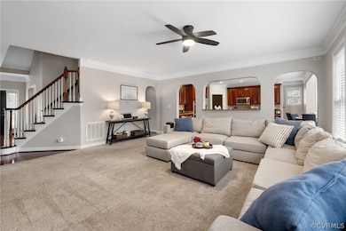 Living room featuring ceiling fan, carpet floors,