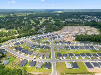 Aerial view of property's location with nearby suburban area