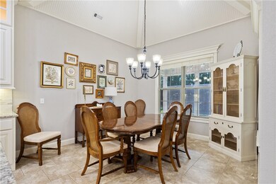Oversized dining space is a showstopper with beadboard vaulted ceiling and overlooks your private backyard.