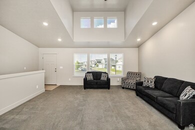 Living room featuring recessed lighting, carpet flooring, and high vaulted ceiling