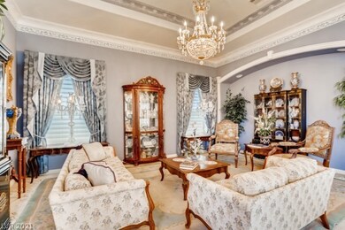 Living room with crown moulding and chandelier