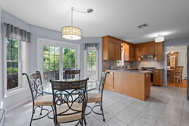 The eat-in kitchen is awash with natural light.