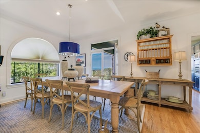 Dining room with wood finished floors, plenty of natural light, and recessed lighting