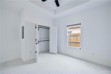 Unfurnished bedroom with marble look tiles, ceiling fan, and electric panel
