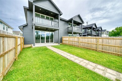 Back of property featuring a ceiling fan, a balcon