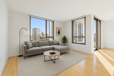 Living area featuring a wall of windows, baseboar