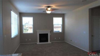 Living room with gas log fireplace, ceiling fan an