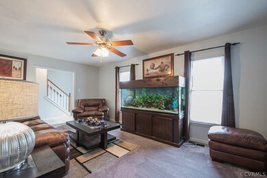 Family room with ceiling fan and fireplace