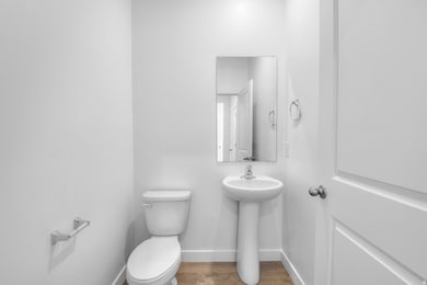 Bathroom featuring toilet and wood finished floors