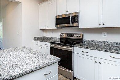 Kitchen with microwave, electric range oven, white