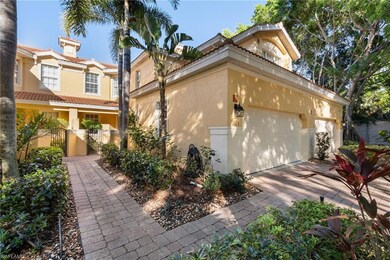 View of property exterior with stucco siding, driveway, a gate, and a tile roof