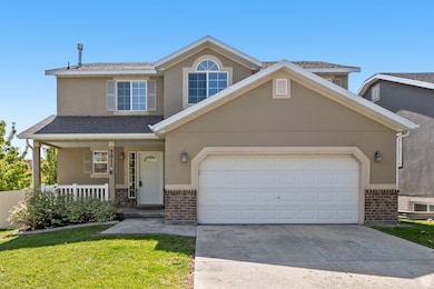 Traditional-style home with a porch, stucco siding, and brick siding