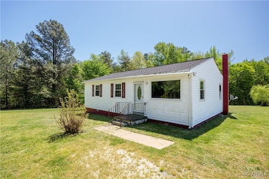 View of front of house featuring a chimney and a f
