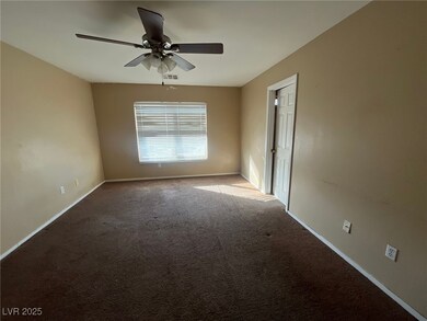 Carpeted empty room with visible vents, ceiling fa