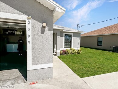 View of exterior entry with stucco siding and a la