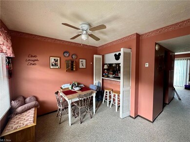 Dining area with carpet floors, a textured ceiling