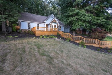 View of front facade with a wooden deck and a fron