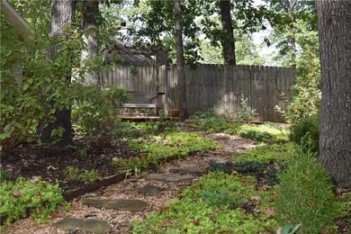 Follow flagstone path through back yard.