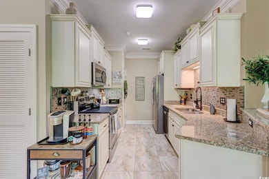 Kitchen with decorative backsplash, light stone co