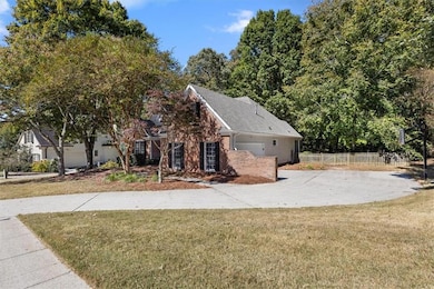 View of front of house with brick siding, driveway, and a shingled roof