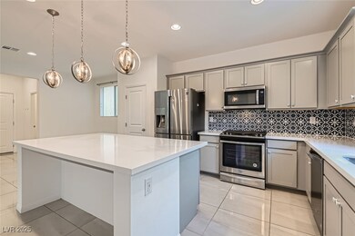 Kitchen featuring gray cabinetry, a kitchen island