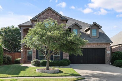 View of front of house with a garage and a front l