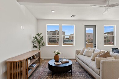 Living room with baseboards and a ceiling fan