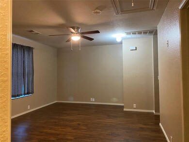 Spare room with a textured ceiling, ceiling fan, a