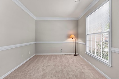 Carpeted spare room featuring visible vents, baseb
