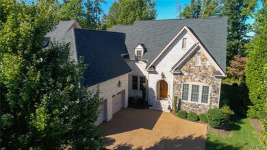 Front view of house showing landscaping and trees