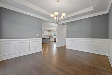 Unfurnished dining area featuring a raised ceiling