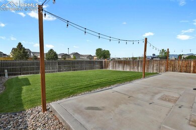 Expansive 37x11 concrete patio with ambient lighting ideal for entertaining, outdoor dining, or relaxing under the stars.