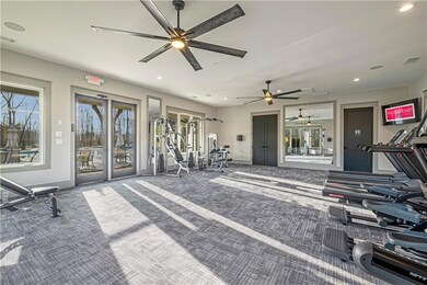 Gym with baseboards, carpet flooring, recessed lig