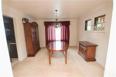 The dining room is connected to the kitchen and living room for easy entertaining.  Take notice of the two stained glass windows.