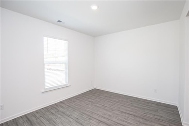 Empty room featuring wood finished floors and recessed lighting