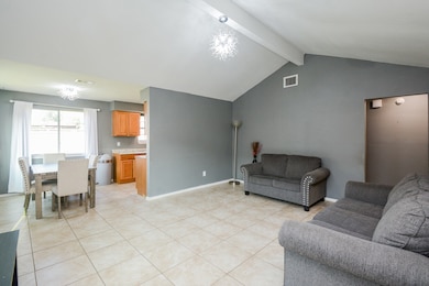 Welcome to your inviting dining area, seamlessly connected to the cozy living space, perfect for gatherings and everyday comfort.