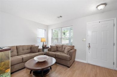 Living area featuring light wood-type flooring and baseboards