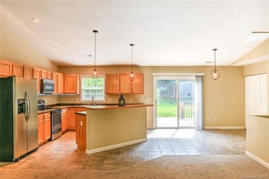 The Kitchen anchors the Living Room and Dining Are