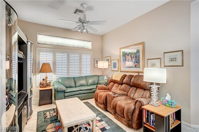 Living room with ceiling fan, light tile patterned