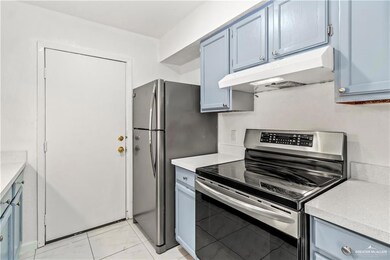 Kitchen featuring stainless steel range with electric stovetop and blue cabinets