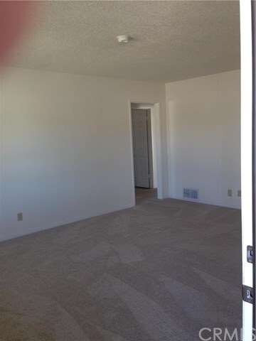 INSIDE LIVING ROOM LOOKING AT BEDROOM ENTRANCES. N