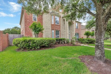This photo showcases a charming two-story home wit