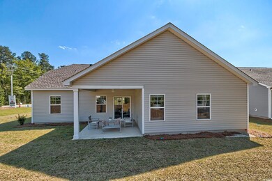 Back of house featuring a yard and a patio area