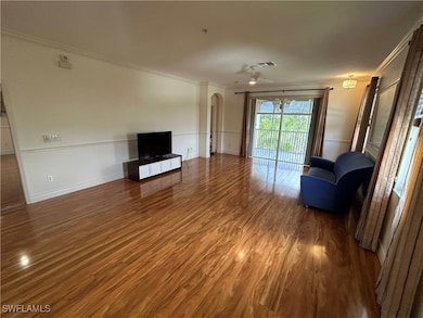 Unfurnished living room featuring crown molding, a
